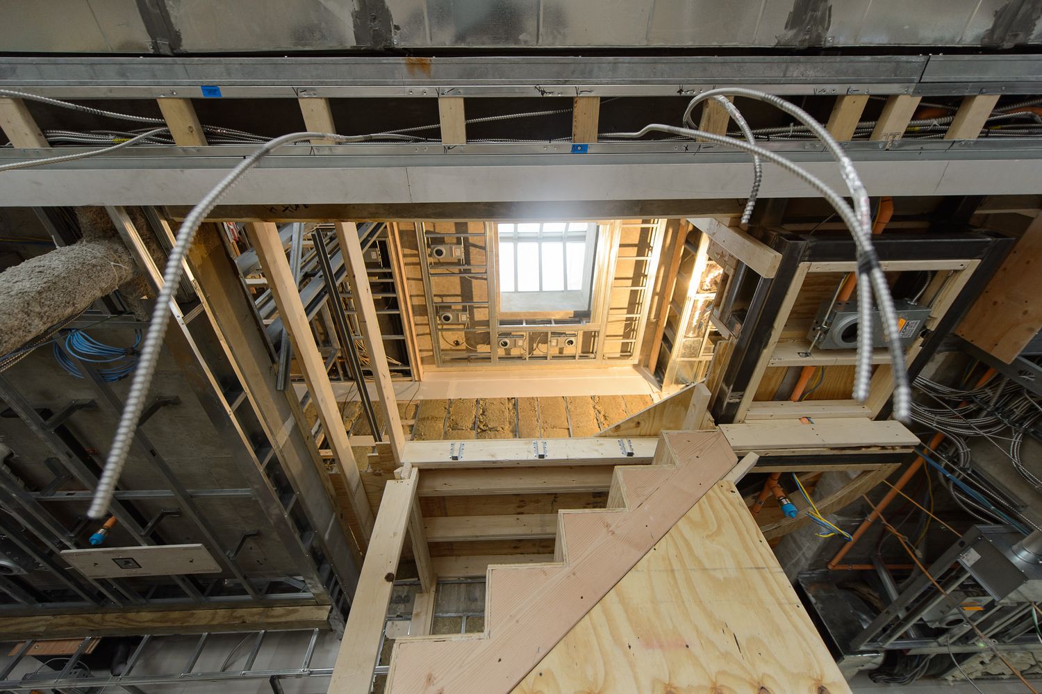 Framing of the floating stair and skylit core at Logan Circle